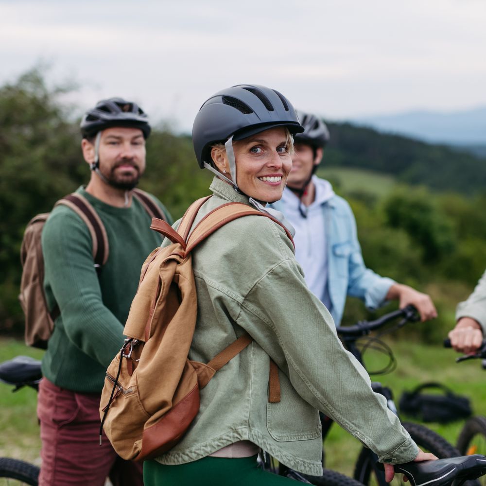 Two people on bicycles with a scenic background