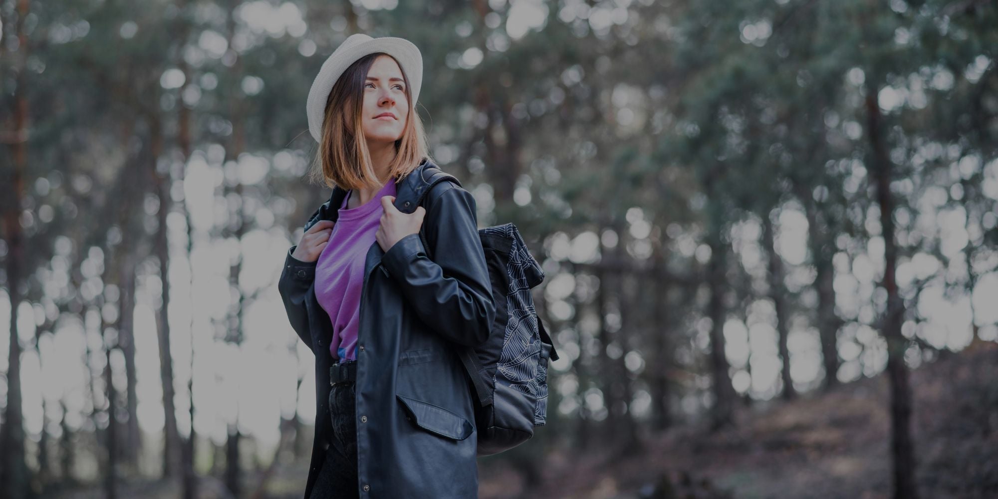 Woman standing in a forest with blurred background